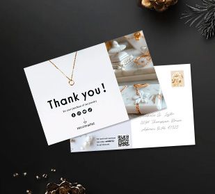 front of and back of postcards on table